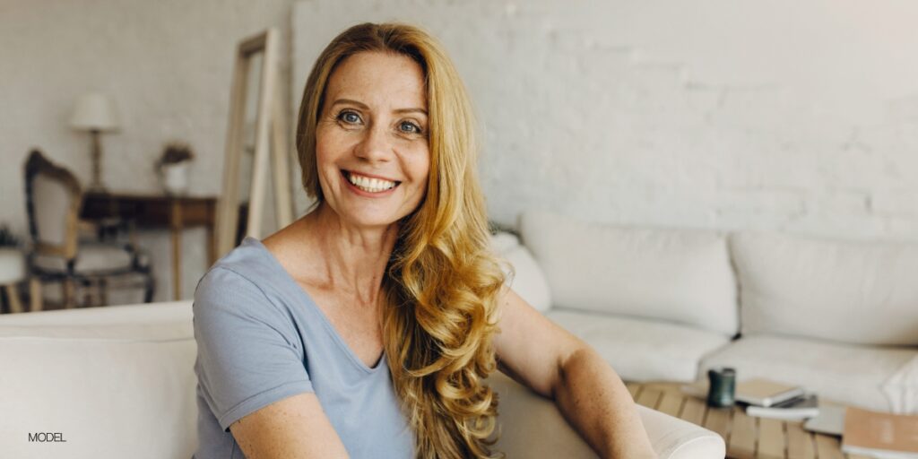 middle age woman smiling midday at the camera after dental implant procedure at Saline oral facial and dental implant surgery in ann arbor